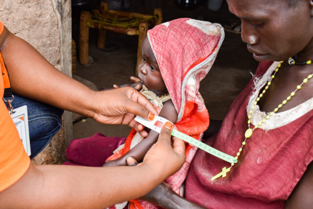 a baby in South Sudan gets an arm measurement
